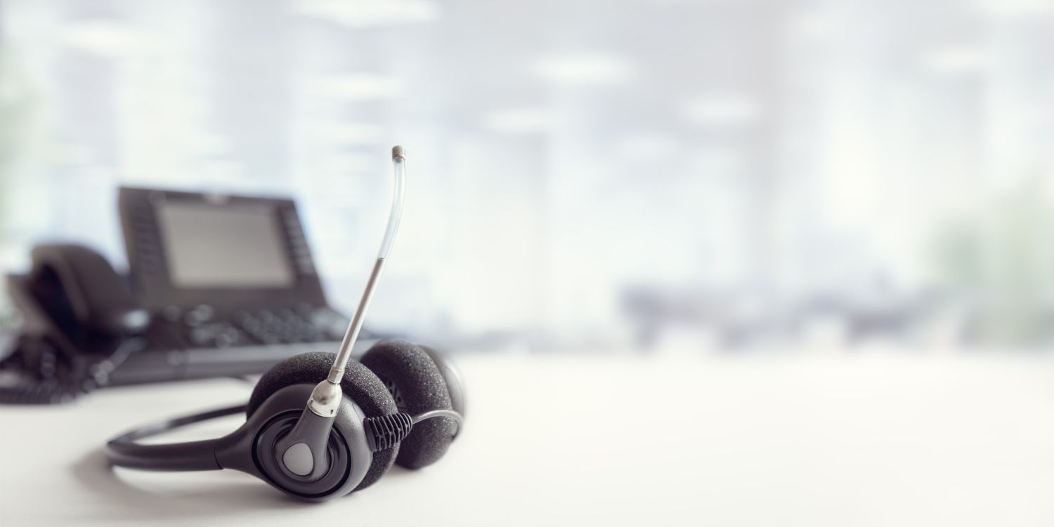 Headset headphones telephone on desk in call centre